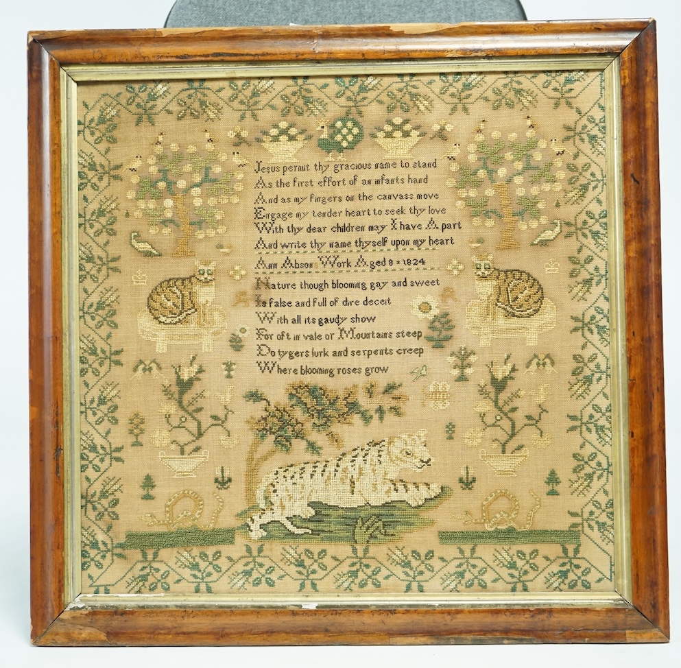 An unusual George IV sampler, ornately worked by Ann Abson, aged 8, dated 1824. A large sampler with a central motif of a recumbent Tiger near two serpants, above are two seated cats, and spot motifs birds in trees, vase